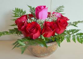 14 red roses 1 pink rose in the center arrangement