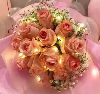 20 Pink roses bouquet in pink paper and LED light string